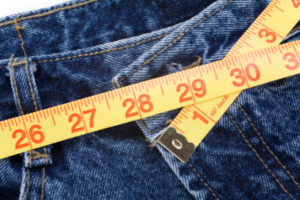 image of jeans with a measuring tape depicting weight loss
